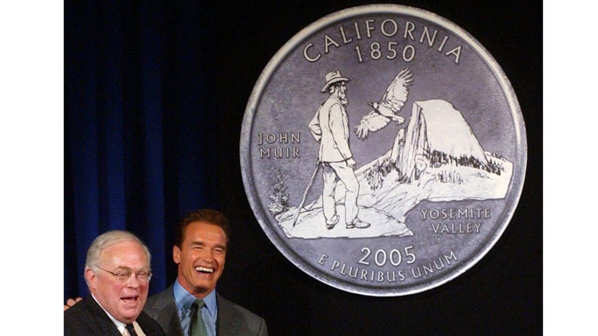 Gov. Arnold Schwarzenegger, right, and then-State Librarian Kevin Starr unveil the design chosen for the California quarter in 2004.