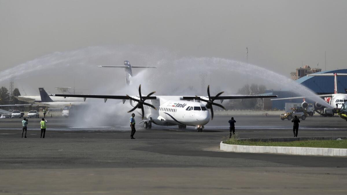 A traditional water cannon salute welcomes a new Iran Air commercial aircraft at Mehrabad airport in Tehran on Aug. 5, 2018. Iran acquired five new ATR72-600 airplanes from a European consortium the day before U.S. sanctions were restored.