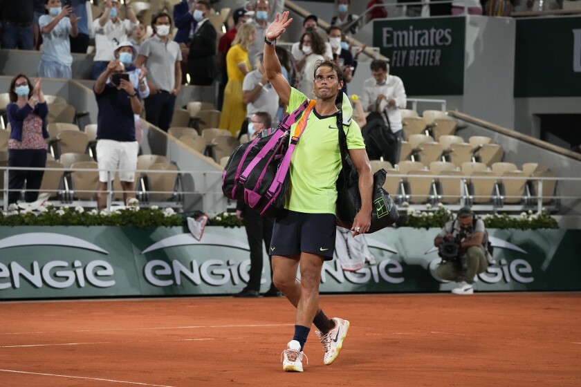 Spain's Rafael Nadal waves after losing to Serbia's Novak Djokovic in their semifinal match of the French Open tennis tournament at the Roland Garros stadium Friday, June 11, 2021 in Paris. Novak Djokovic won 3-6, 6-3, 7-6 (4), 6-2. (AP Photo/Michel Euler)