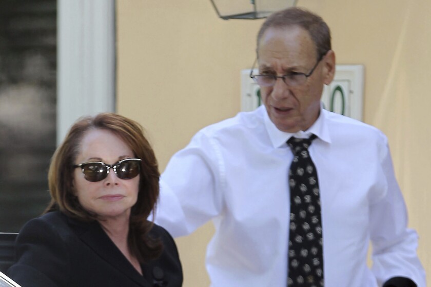 FILE - Shirley Sotloff and her husband, Arthur B. Sotloff, exit a car as they return home after a memorial service for their son, slain journalist Steven Sotloff, at Temple Beth Am, Friday, Sept. 5, 2014, in Pinecrest, Fla. The family of slain American journalist Steven Sotloff filed a federal lawsuit Friday, May 13, 2022, accusing prominent Qatari institutions of wiring $800,000 to an Islamic State “judge” who ordered the murder of Sotloff and another American journalist, James Foley. (Carl Juste/Miami Herald via AP, File(