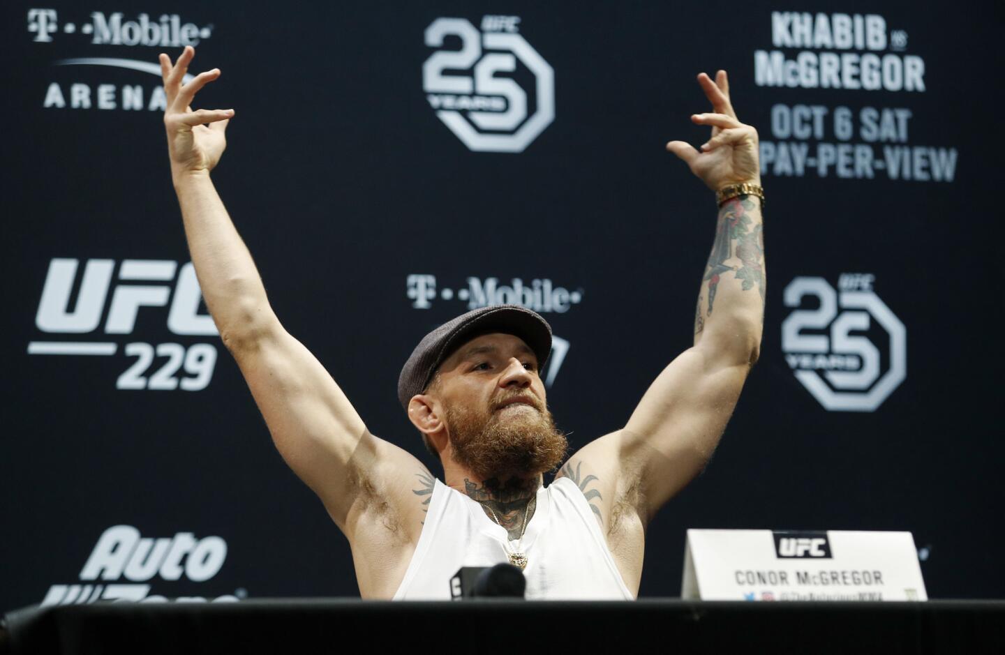 Conor McGregor raises his arms during a news conference for the UFC 229 mixed martial arts bouts Thursday, Oct. 4, 2018, in Las Vegas. McGregor is scheduled to fight Khabib Nurmagomedov on Saturday in Las Vegas. (AP Photo/John Locher)