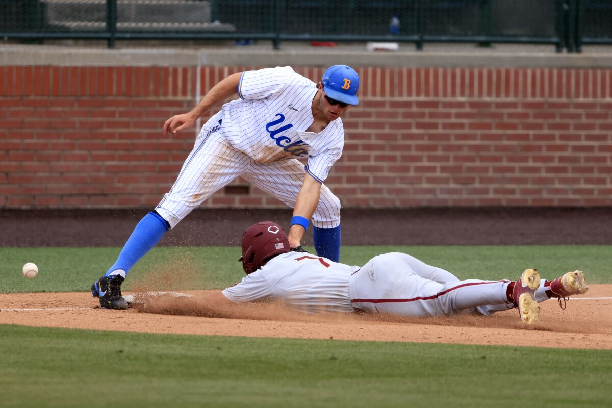 UCLA third baseman Kyle Karros can't handle the throw as Florida State's Jaime Ferrer (7) slides in safely June 3, 2022.