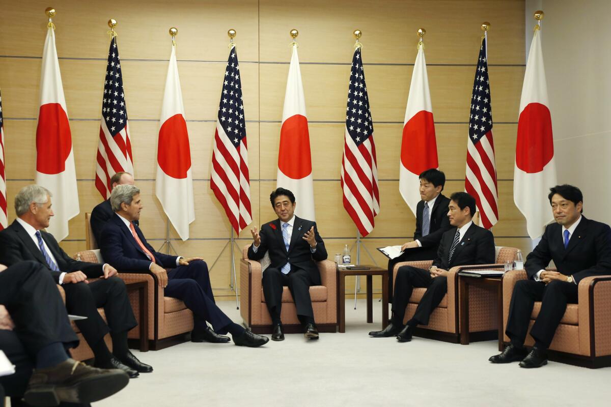 Japanese Prime Minister Shinzo Abe, center, speaks as U.S. Defense Secretary Chuck Hagel, left, U.S. Secretary of State John Kerry, second from left, Japanese Foreign Minister Fumio Kishida, second from right, and Japanese Defense Minister Itsunori Onodera listen during their meeting at the prime minister's official residence in Tokyo.