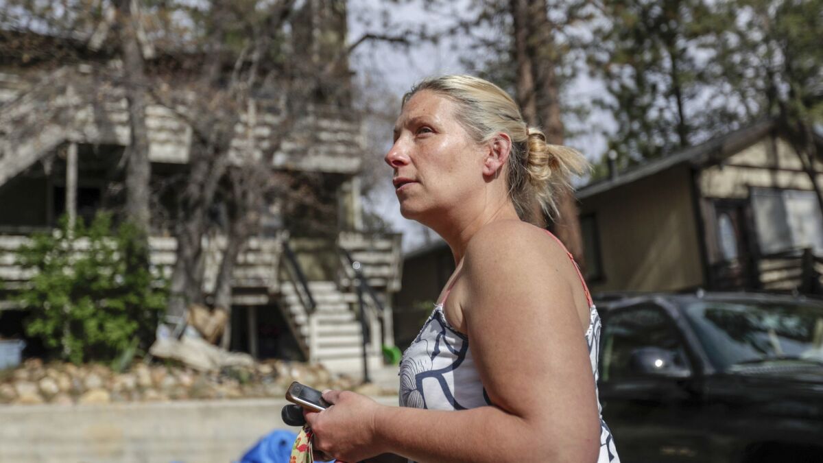 Amanda Mayer is aware of the fire danger presented by overhanging branches over her two-story home in the residential community of Sugarloaf near Big Bear City.