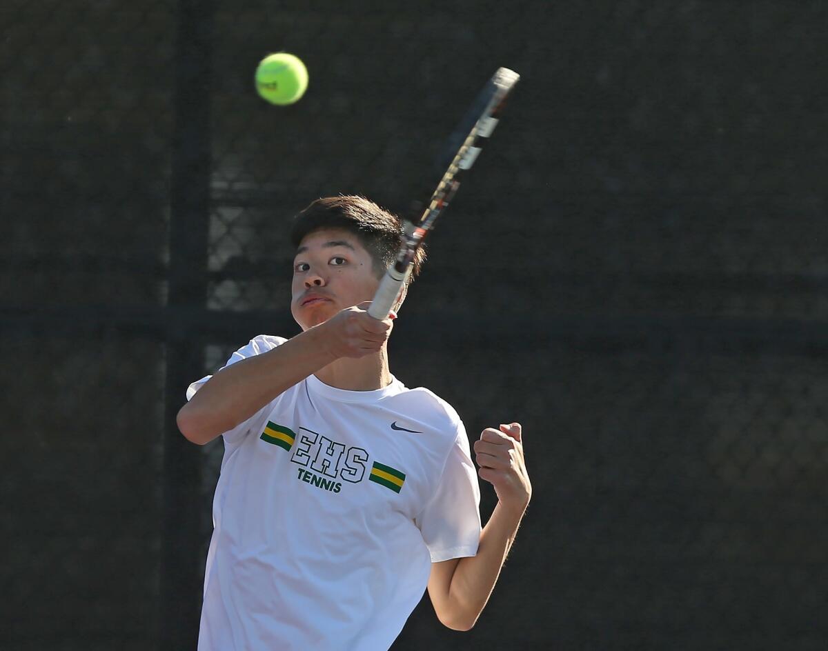 Edison High's Ryan Lum, playing No. 1 doubles, hits a return during a Wave League match at Laguna Beach on Thursday.