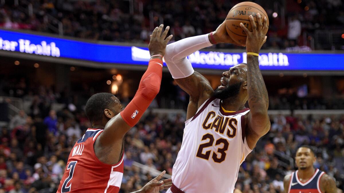 Cavaliers forward LeBron James pulls up for a shot over Wizards guard John Wall during the first half Friday.