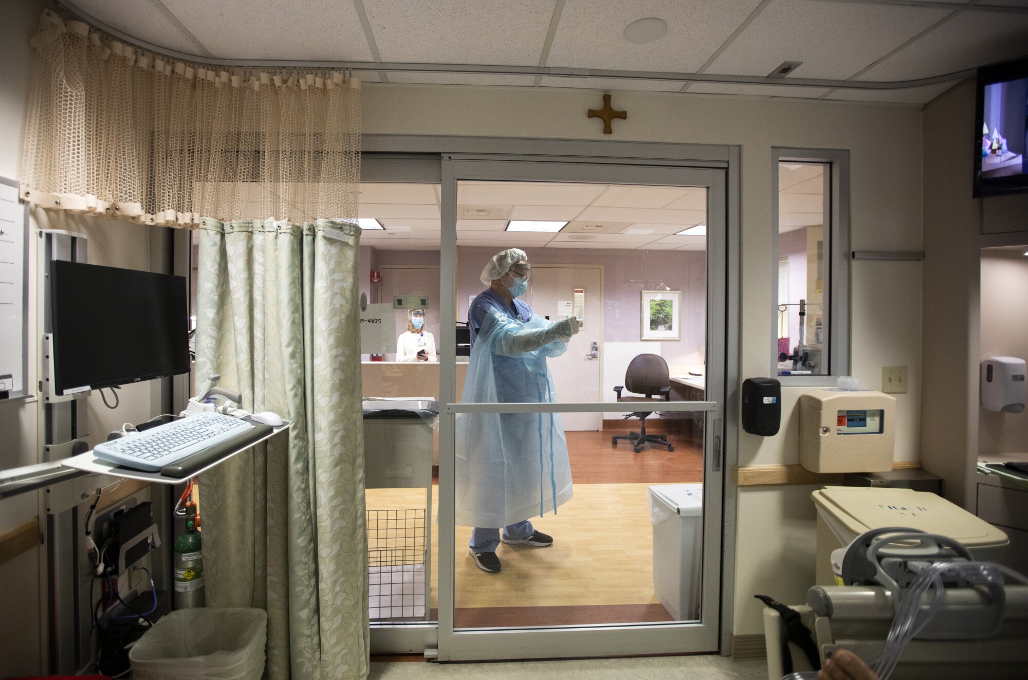 Juan Richardson of RCP Respiratory Services dons his isolation gown