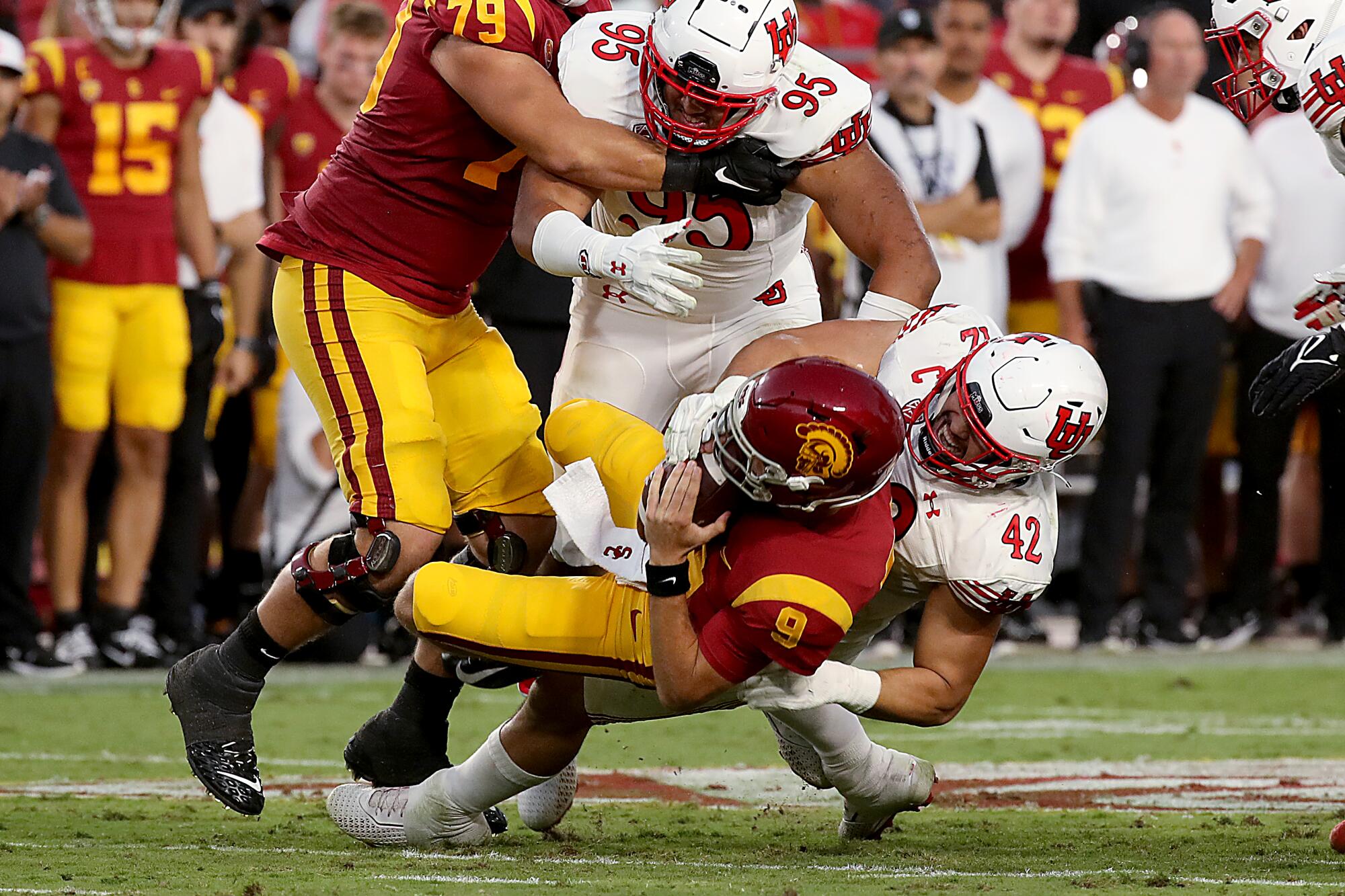 USC quarterback Kedon Slovis gets slammed to the turf by Utah's Mika Tafua.