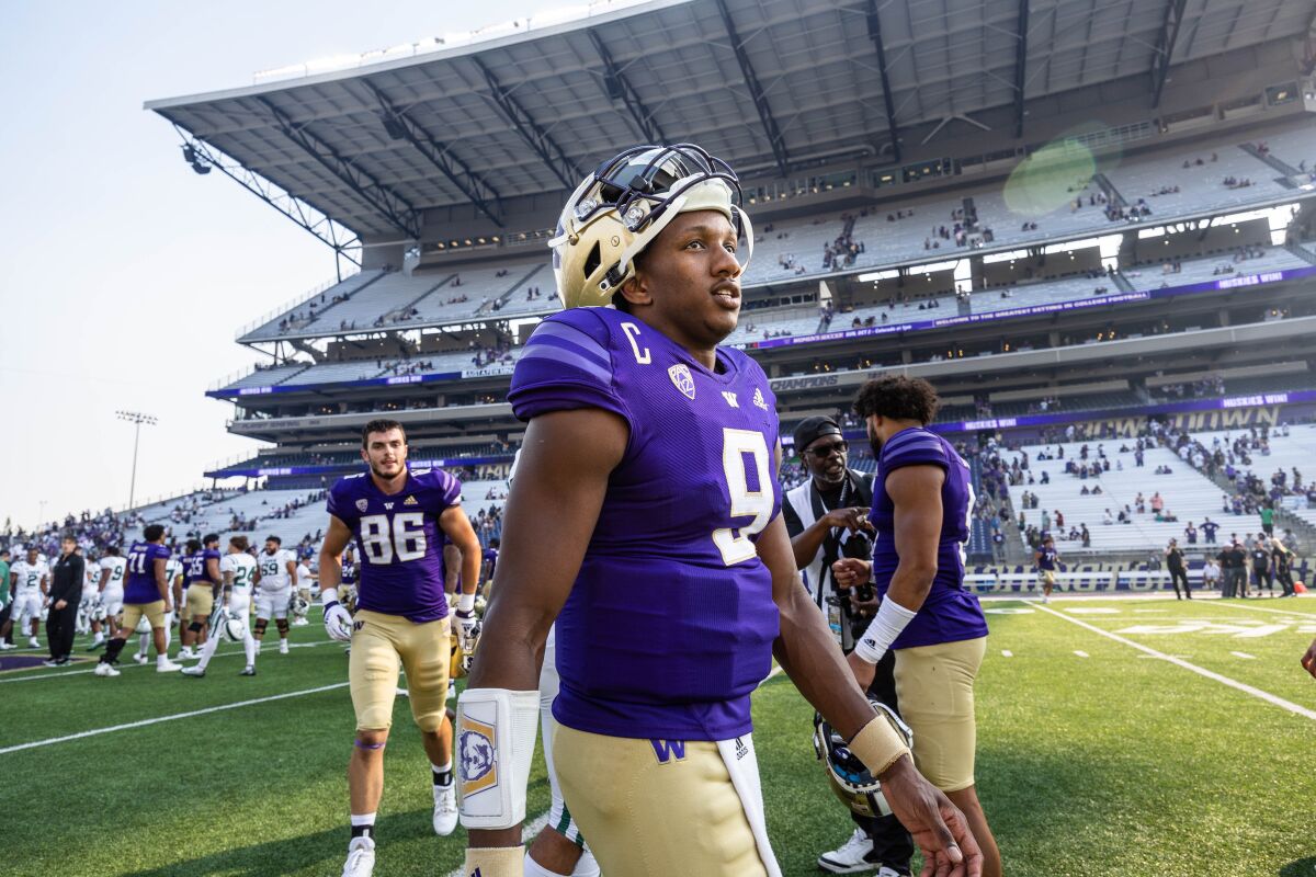 Washington quarterback Michael Penix Jr. walks off the field after an NCAA college football game against Portland State in Seattle, Saturday, Sept. 10, 2022. Penix was 20-27 passing with 337 yards and two touchdowns. (Dean Rutz/The Seattle Times via AP)