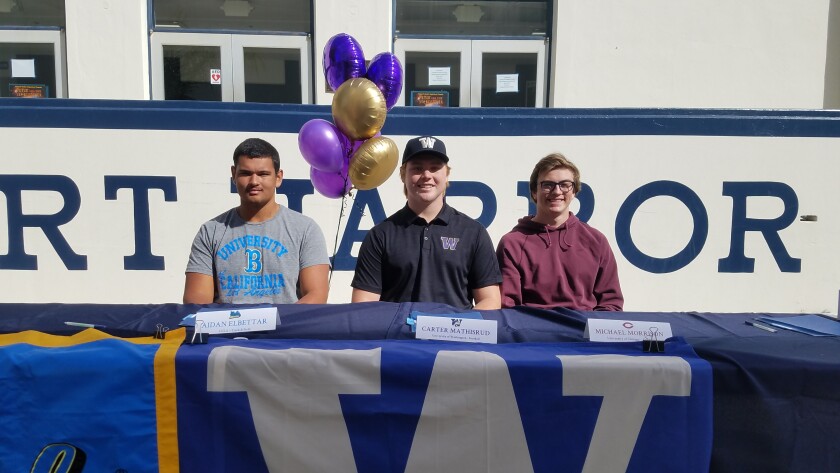 Newport Harbor's Aidan Elbettar, left, Carter Mathisrud and Michael Morrison participate in Wednesday's signing day event on campus.
