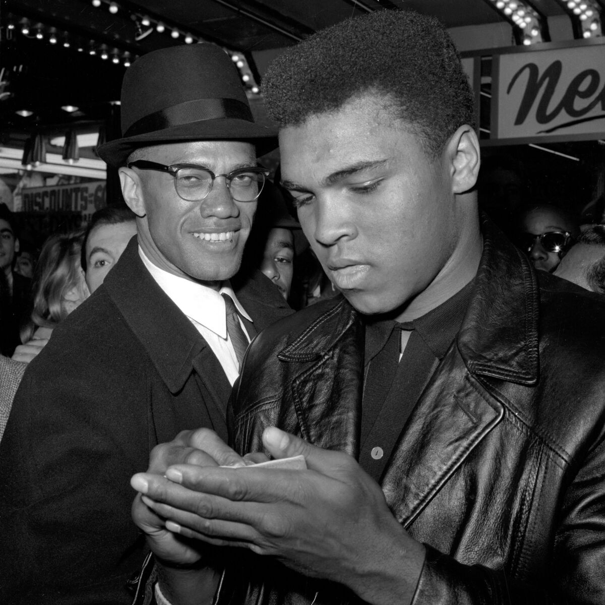 Muhammad Ali, right, stands with Malcolm X 