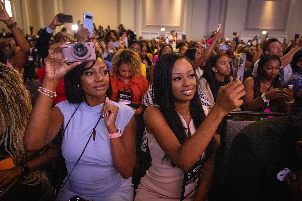 NABJ attendees hold up their phones.