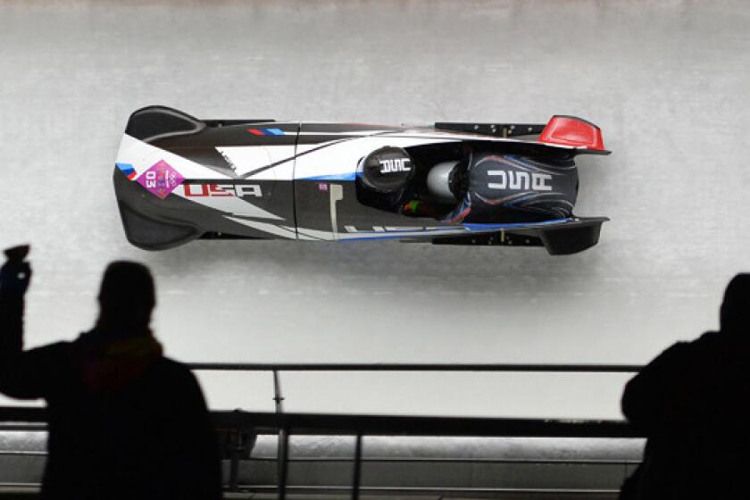 American pilot Jamie Greubel, left, and brakewoman Aja Evans take part in their first run in the women's two-man bobsled competition at the Sochi Winter Olympic Games on Tuesday. Evans' rise as an Olympian has been a source of pride for her family.