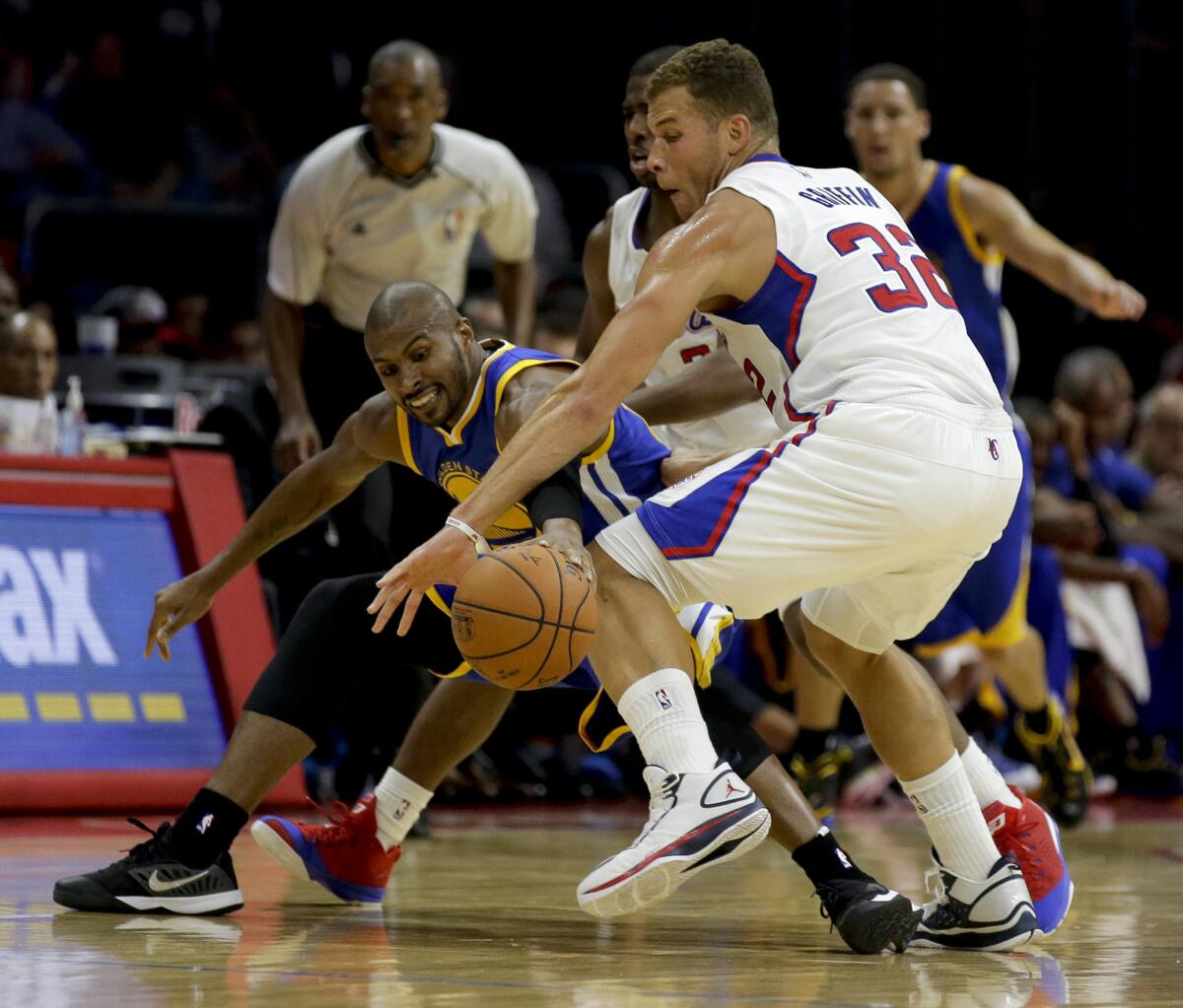 Clippers forward Blake Griffin steals the ball from Golden State Warriors guard Leandro Barbosa on Oct. 7.