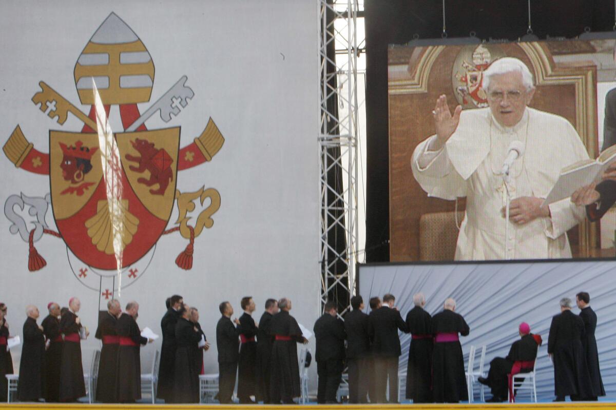 Bishops watch Pope Benedict XVI on a large video monitor during a rally in 2008.