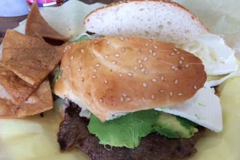 A cemita with a pounded sheet of beef bigger than the bun.