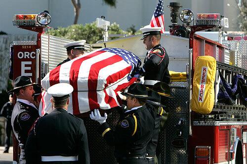 The casket of Msgr. Sammon arrives at the Crystal Cathedral on Engine 55. The fire engine was driven by grandnephew Mike Tooley, an engineer for the Orange County Fire Authority.