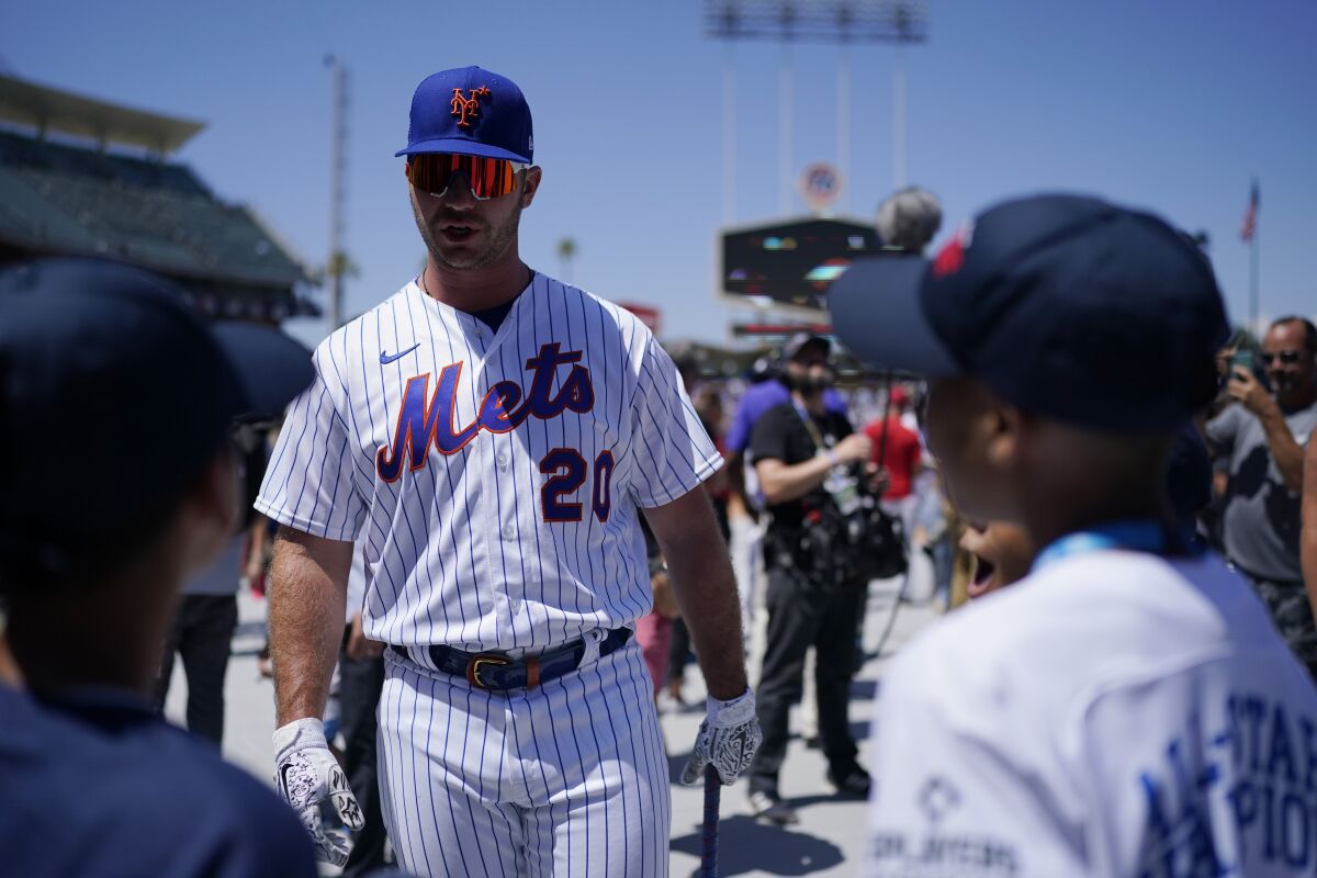New York Mets' Pete Alonso talks to fans during batting practice a day before.