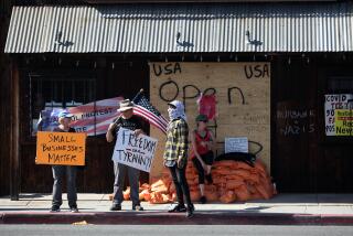 LOS ANGELES, CA - APRIL 09: People gather outside Tinhorn Flats bar and restaurant to rally in support of its opening and to protest city mandates for it to close in Burbank on Friday, April 9, 2021 in Los Angeles, CA. (Dania Maxwell / Los Angeles Times)