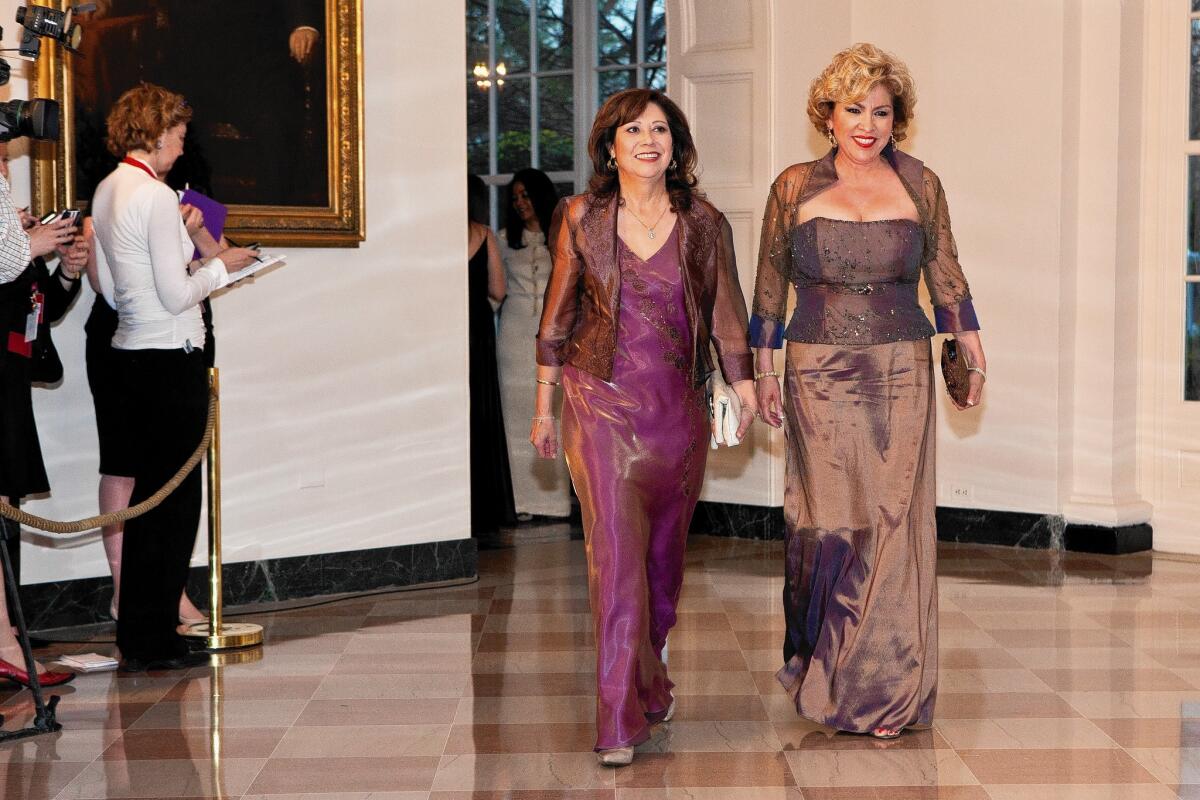 Then-Secretary of Labor Hilda Solis, left, and Rebecca Zapanta arrive for a state dinner in honor of British Prime Minister David Cameron at the White House on March 14, 2012.