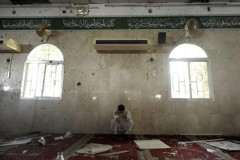 A man sits alone after a bombing at a Shiite mosque in the eastern Saudi town of Qudayh, near the regional center of Qatifi, on May 22.