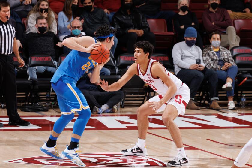 Stanford's Brandon Angel, right, defends Jaime Jaquez Jr. of UCLA on Feb. 8 at Maples Pavilion in Stanford.