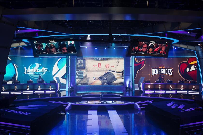 The screen in the center shows a video game competition between teams Luminosity, left, and Renegades, right, in the ELeague arena at Turner Studios in May.