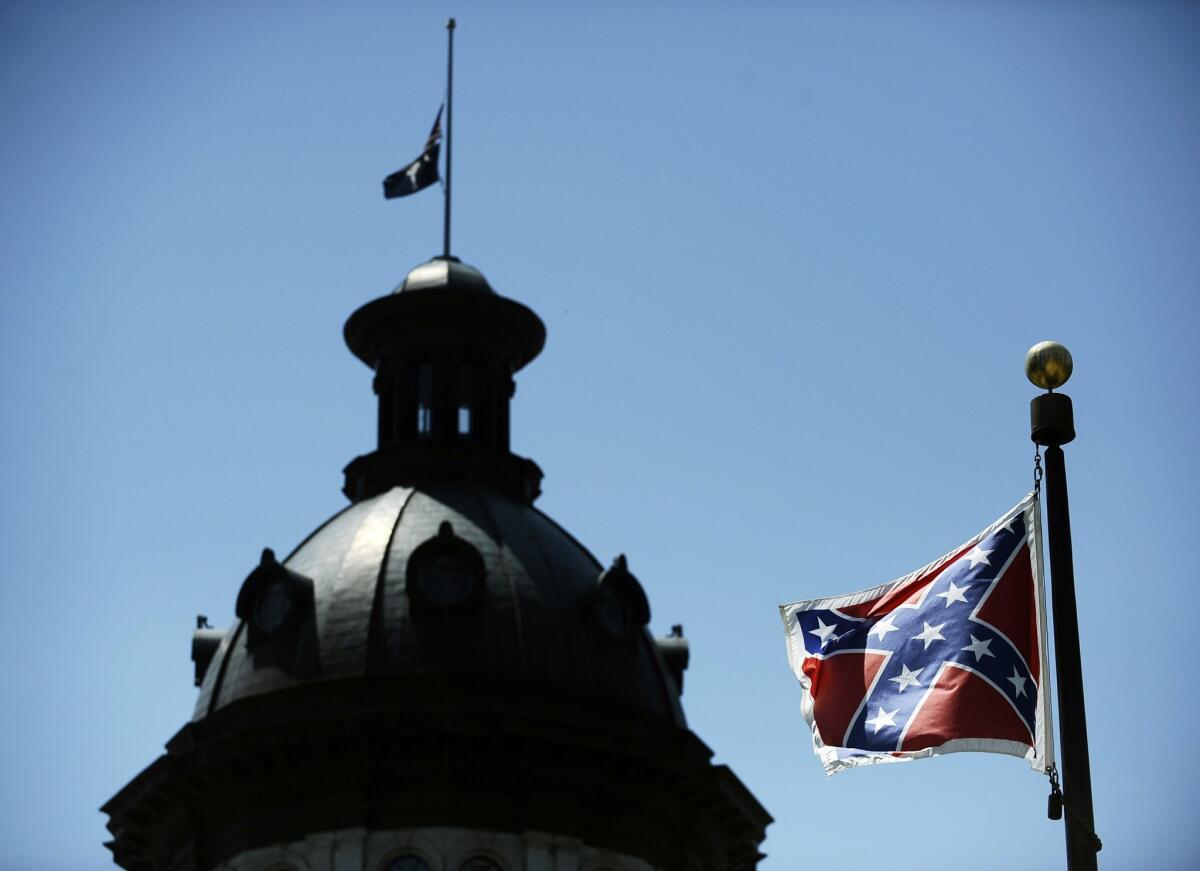 In this June 19, 2015, photo, a Confederate flag flies near the South Carolina Statehouse in Columbia, S.C. Whether South Carolina should continue to fly the Confederate flag on its statehouse grounds is the latest in a series of issues to arise this summer challenging the GOP’s effort to build the young and diverse coalition of voters it likely needs to win the White House. (AP Photo/Rainier Ehrhardt) The Associated Press