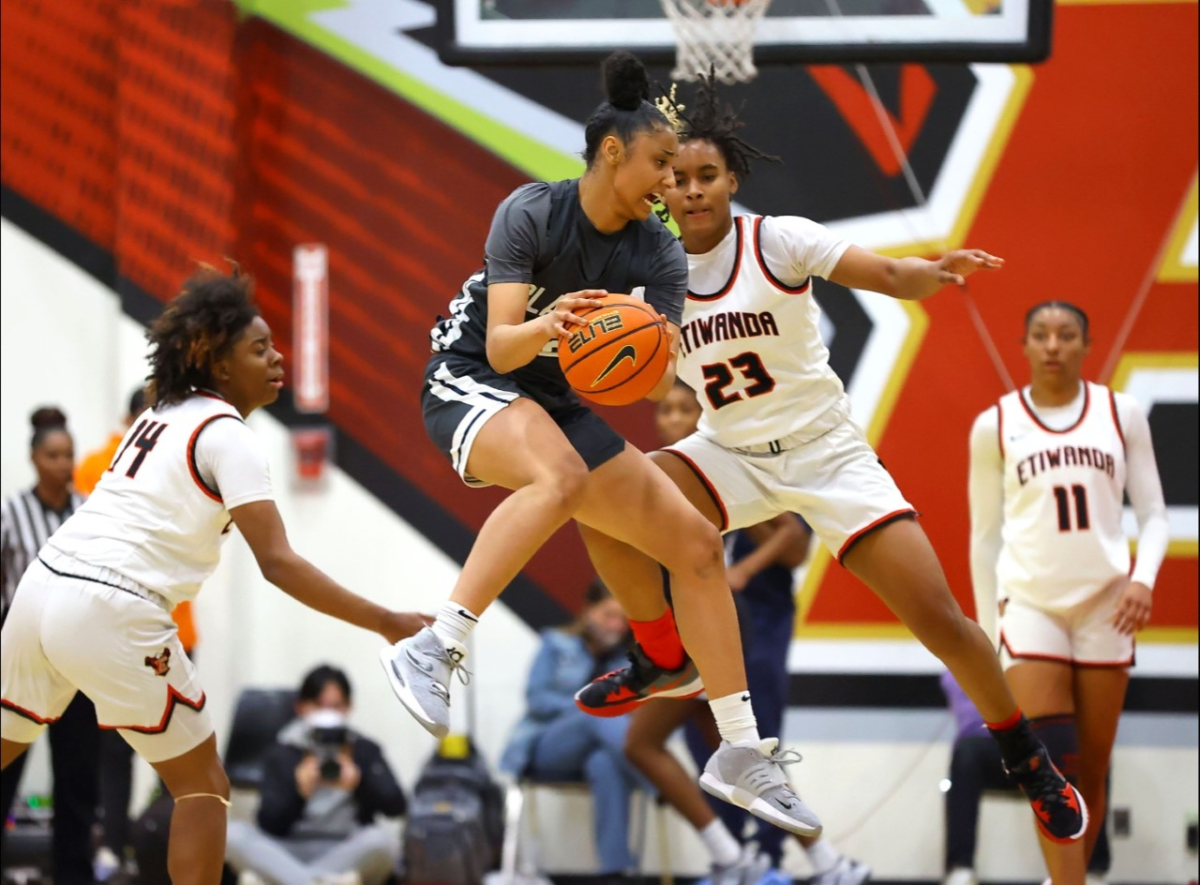 Sierra Canyon star Juju Watkins, with the ball, battles Etiwanda on Saturday night. 