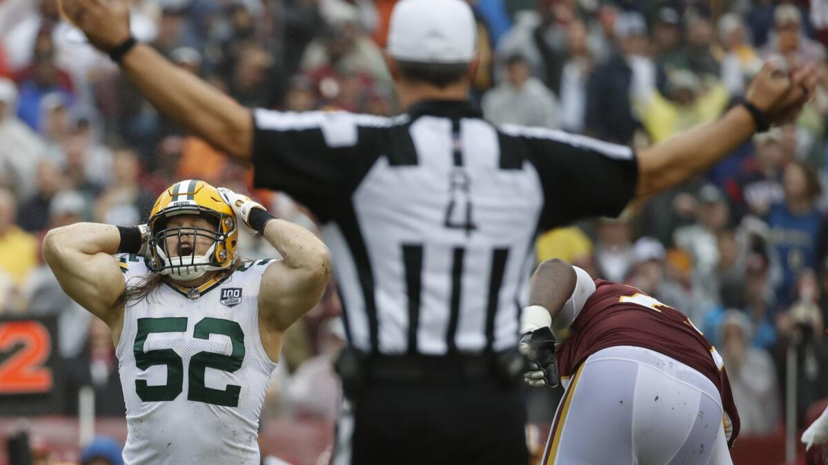 Clay Matthews, left, reacts after being called for roughing the passer for a third straight week.