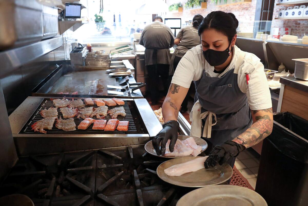 Sous Chef Carla Arce cooks at the O Sea restaurant in Old Town Orange.