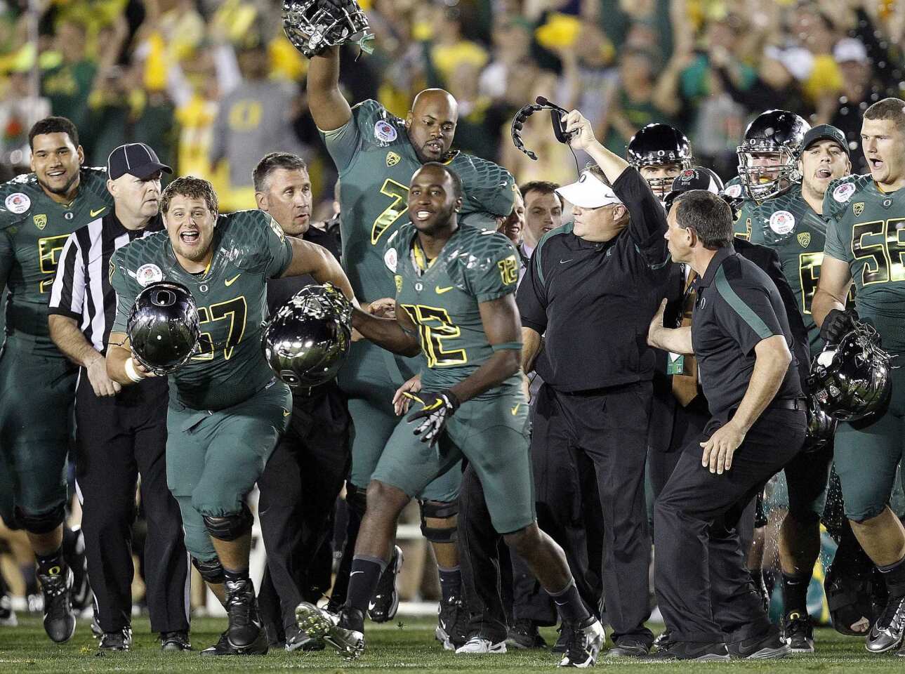 Oregon players and Coach Chip Kelly begin to celebrate after a 45-38 victory over Wisconsin in the Rose Bowl on Monday.