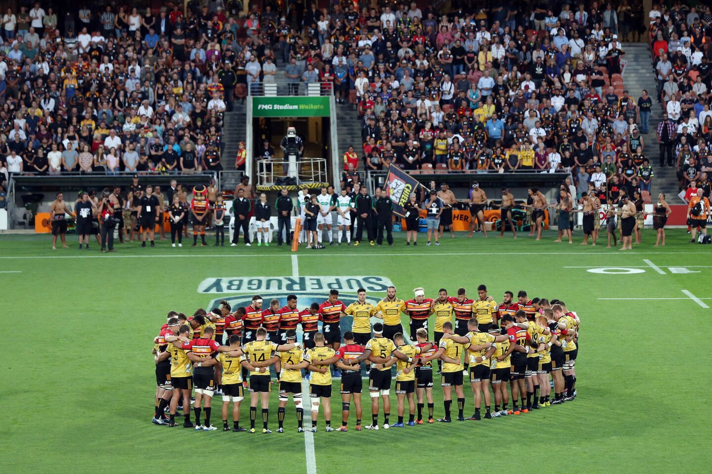 The Chiefs and Hurricanes observe a moment of silence Friday before a Super Rugby match at FMG Stadium in Hamilton, New Zealand.