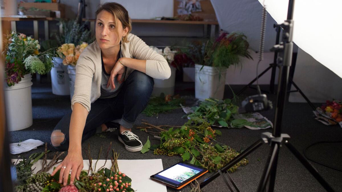 BloomThat stylist Stevie Wazna-Blank arranges flowers during a photo shoot of an upcoming lookbook at the company's headquarters in San Francisco.