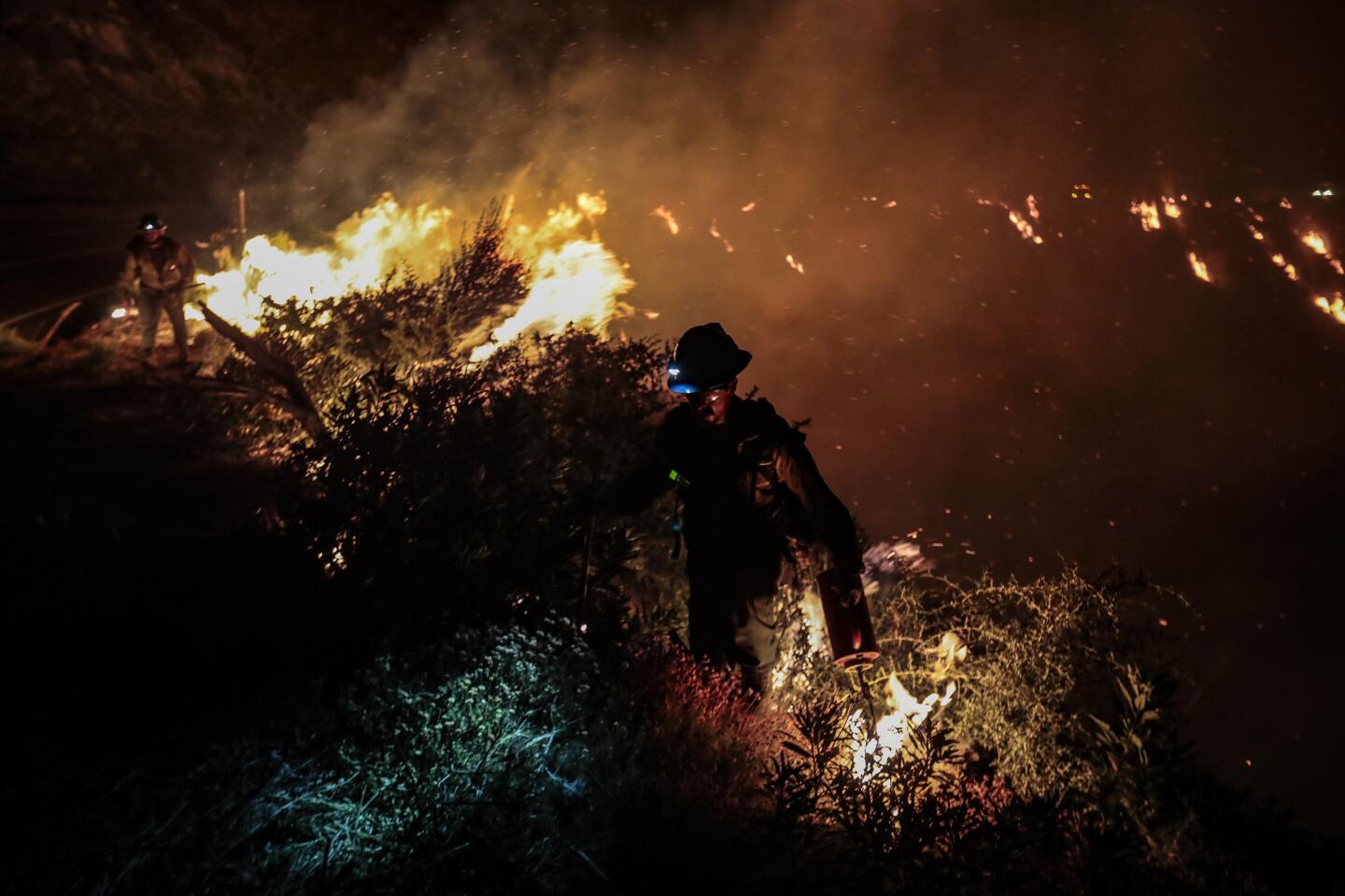 Hot shot crew members fight the Bobcat fire
