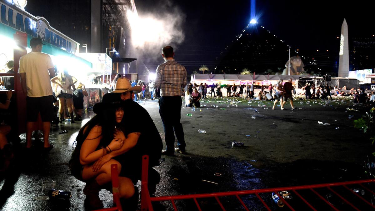 People take cover at the Route 91 Harvest country music festival after gunfire from the Mandalay Bay Resort and Casino in 2017.