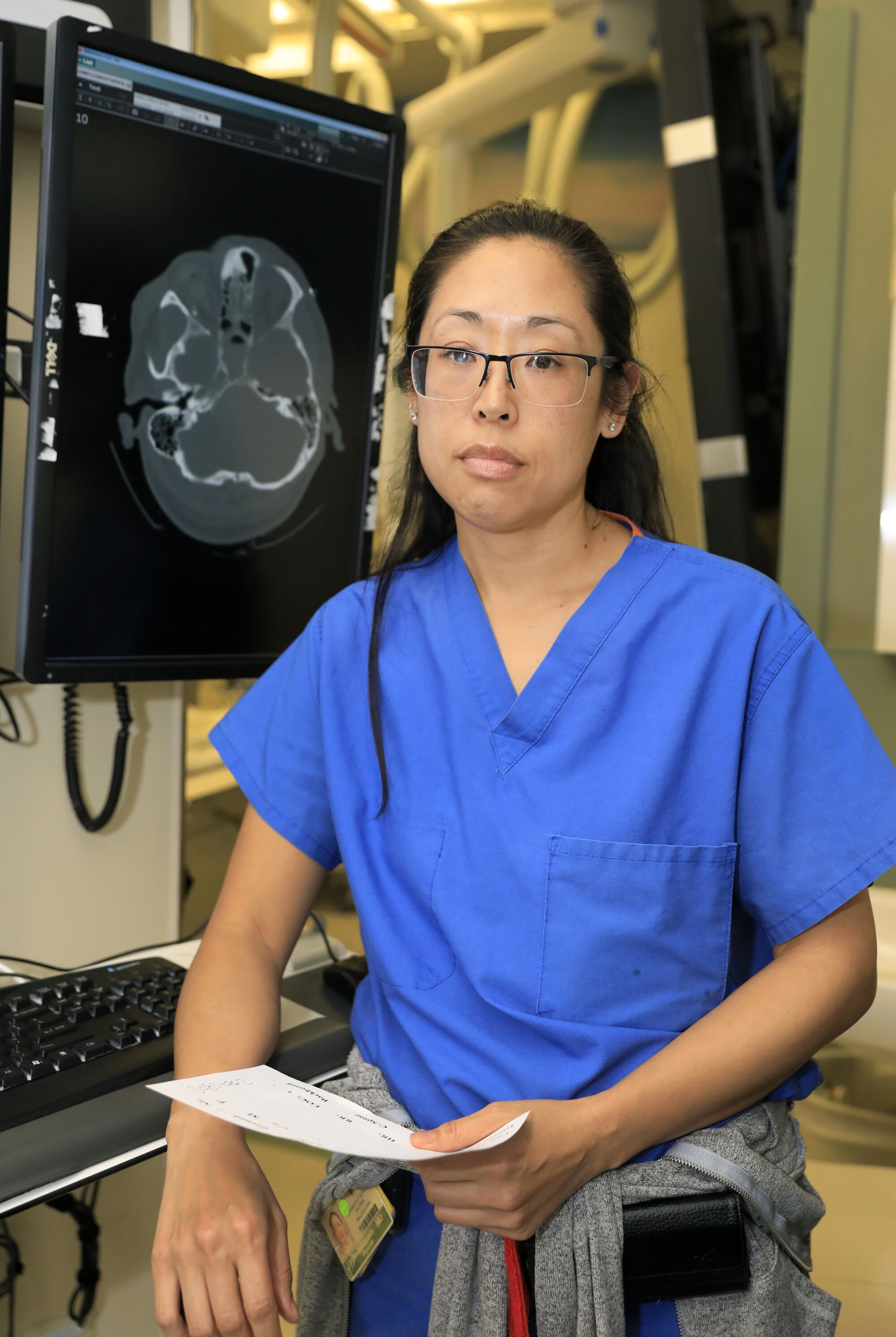 Dr. Leslie Kobayashi, a trauma surgeon at UC San Diego Medical Center in Hillcrest is pictured with an x-ray image of a head injury in the trauma area of the emergency room.