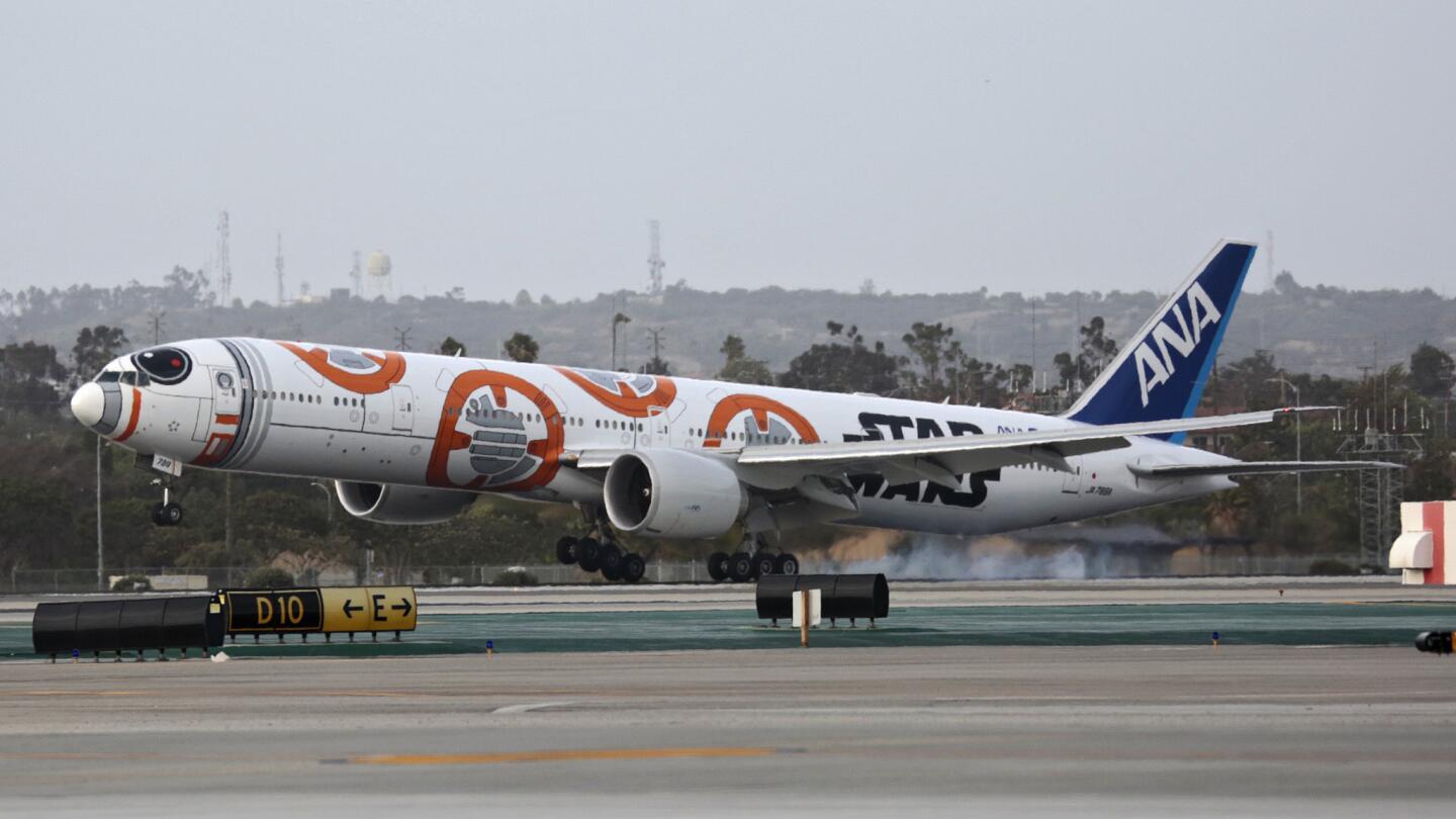 A "Star Wars"-themed Boeing 777-300 decorated like the movie's character BB-8 lands in Los Angeles on March 28.