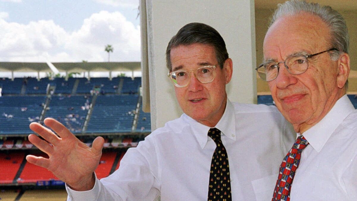 Former Dodgers owner Peter O'Malley, left, and then-new owner Murdoch look over the playing field on opening day in Los Angeles in 1998. Murdoch sold the team in 2004.