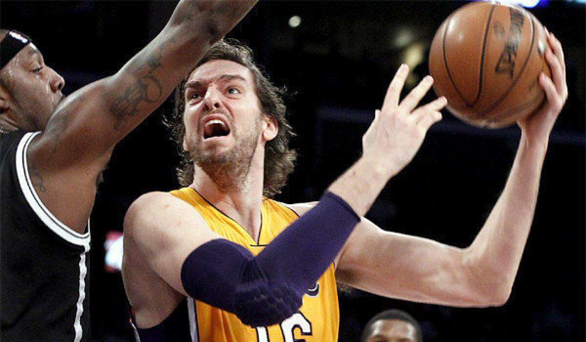 Big man Pau Gasol shoots and scores over Nets forward Andray Batche in the second quarter of the Lakers' 95-90 win Tuesday.