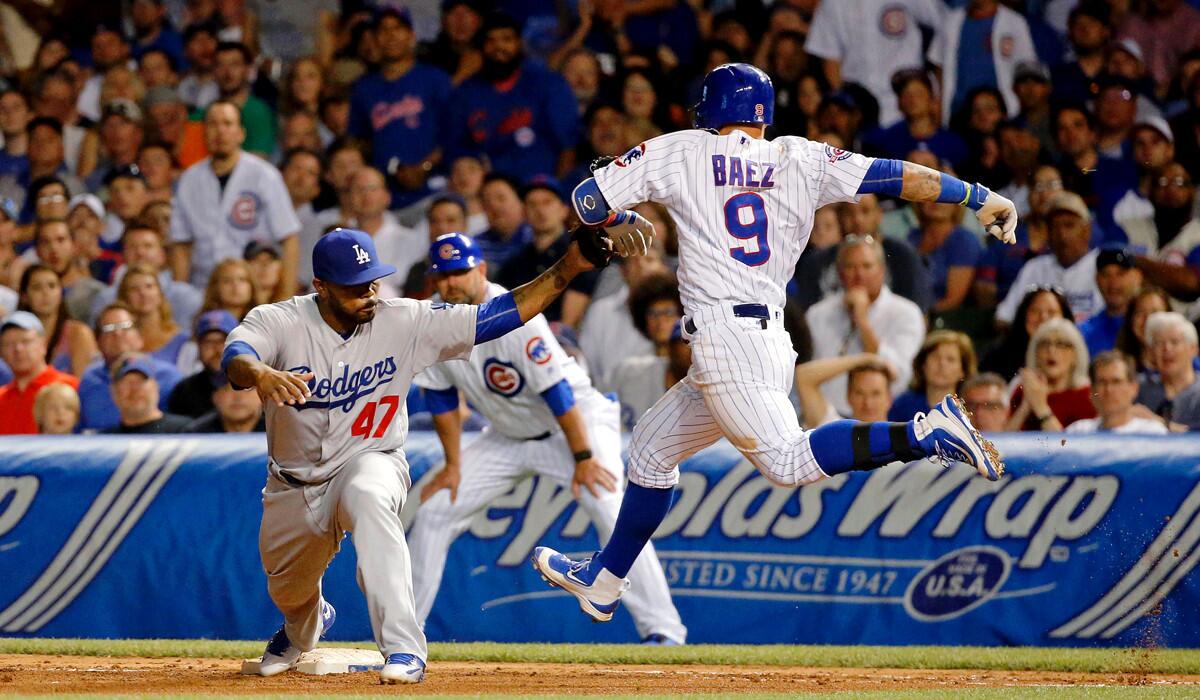 Dodgers' Howie Kendrick, left, forces out Chicago Cubs' Javier Baez during the seventh inning Wednesday.