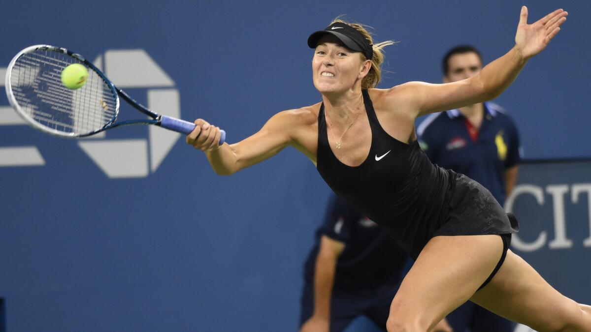 Maria Sharapova returns a shot during her first-round win over Maria Kirlenko at the U.S. Open on Monday.