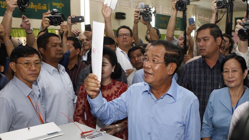 Cambodian Prime Minister Hun Sen looks his ballot at a polling station in Takhmau, Kandal province, on July 29, 2018.