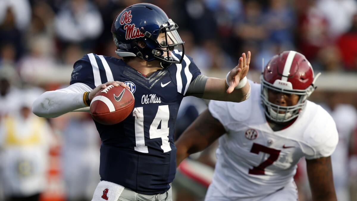 Mississippi quarterback Bo Wallace passes in front of Alabama linebacker Ryan Anderson during the Rebels' upset win over the Crimson Tide on Saturday.