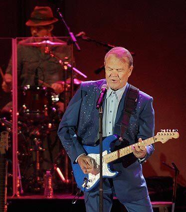 Glen Campbell performs at the Hollywood Bowl on June 24, 2012, as part of his goodbye tour. Before Campbell, who announced in 2011 that he was living with Alzheimer's disease, took the stage Sunday evening, a cast of singing admirers lined up to pay homage. They included Lucinda Williams, Kris Kristofferson and Jackson Browne.