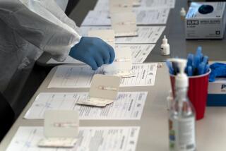 A nurse processes COVID-19 rapid antigen tests at a testing site in Long Beach, Calif., Thursday, Jan. 6, 2022.