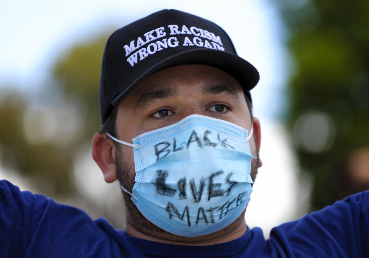 Protester wearing mask with the words "Black Lives Matter"