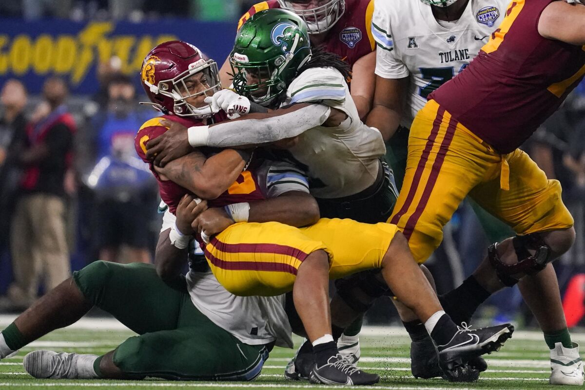 USC running back Austin Jones is tackled by Tulane players during the second half Monday.
