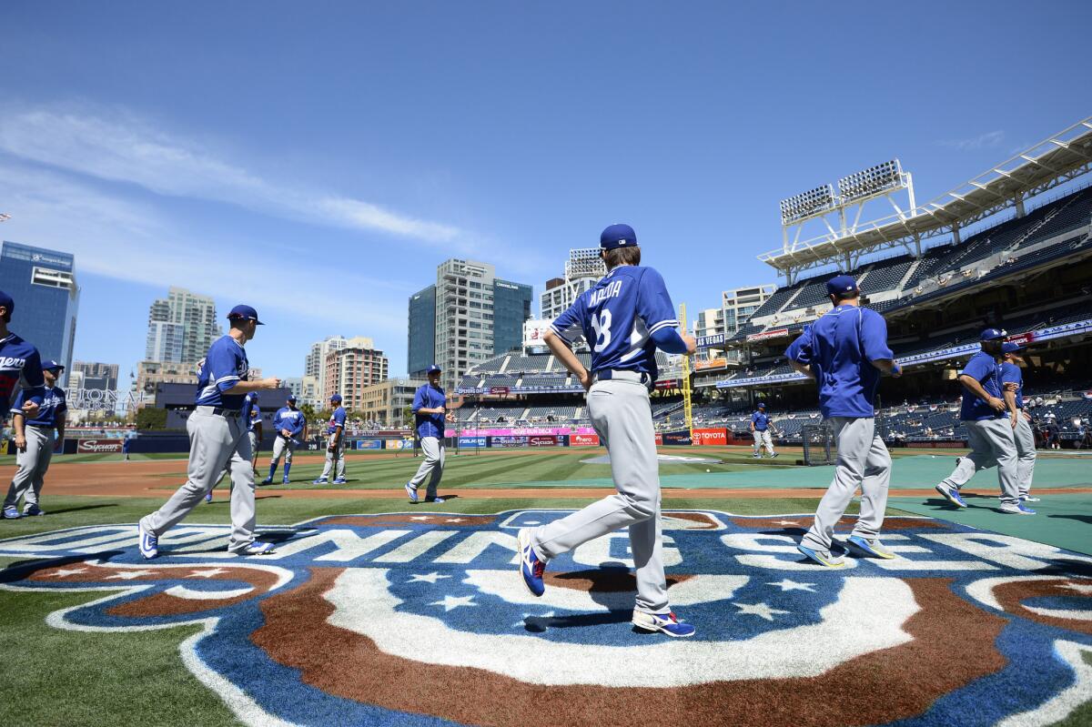 The Dodgers warm up before their season opener against the Padres in San Diego on April 4.