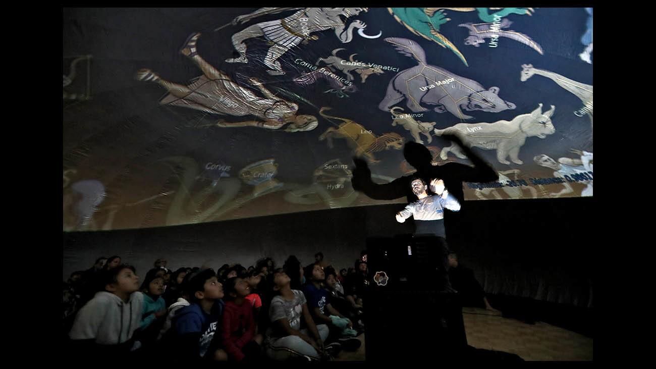 Oak View Elementary School students view the constellations projected on an inflatable mobile planetarium as presenter Mario Tomic talks about the night sky, at the school in Huntington Beach on Friday, Nov. 30, 2018. Besides talking about constellations, Tomic explained how to find the North Star and talked about planets like Jupiter and moons like our own, Galileo and Io.